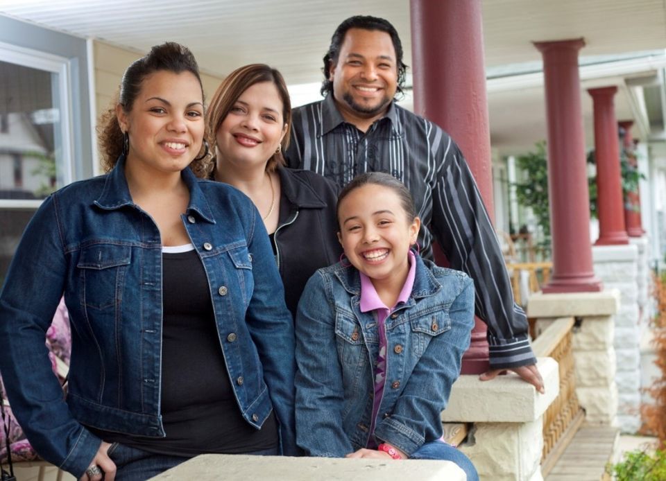 A family posing for a picture on a porch