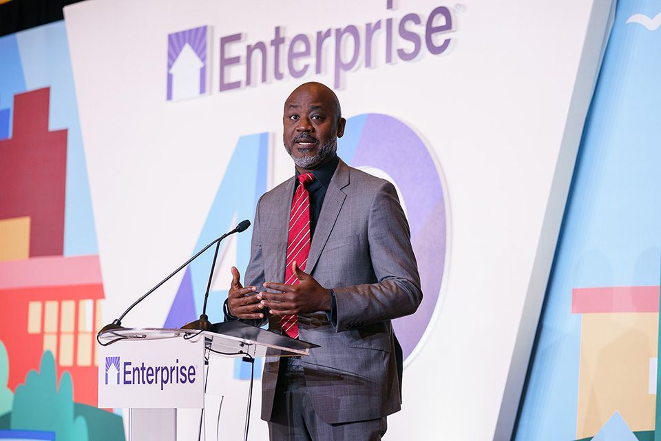 Otis Rolley, President of Wells Fargo Foundation and Head of Philanthropy and Community Impact, standing and speaking at a podium