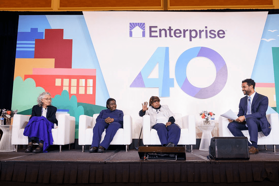 Brian McLaughlin, president of ECD, speaks with a panel with three older women seated