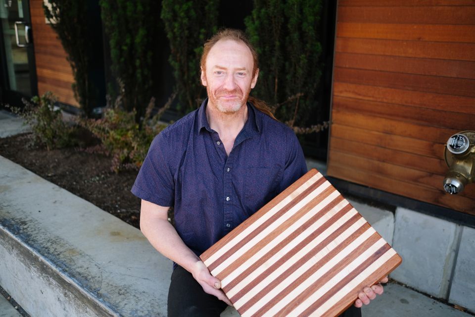 Dennis Willard at HopeWorks with cutting board