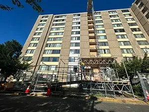 Skyward view of an apartment building with scaffolding in front