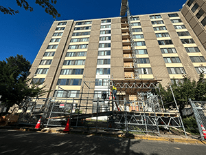 Skyward view of an apartment building with scaffolding in front