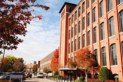 Streetview of a green-certified apartment building with trees in the foreground