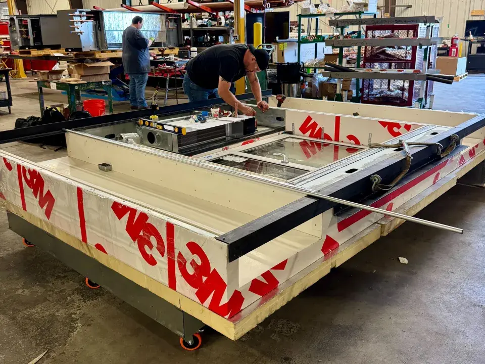 Worker constructs large horizontal panel