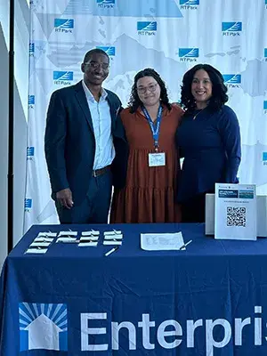 People standing at the registration table at the USVI Affordable Housing Workshop