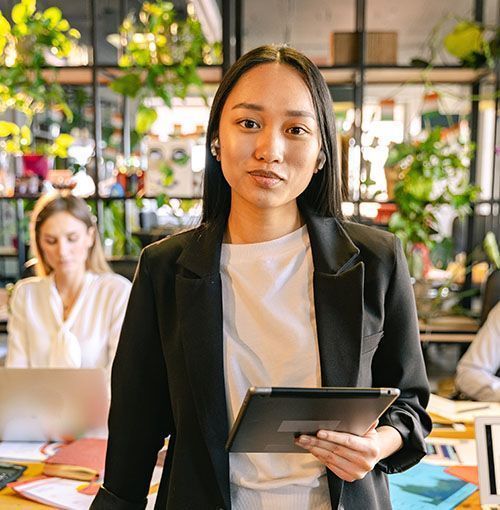 Woman in an office holding a tablet