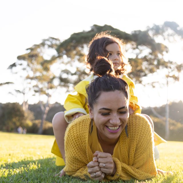 family playing in the grass