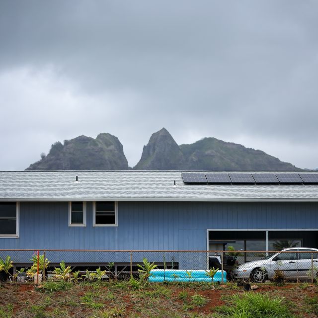 A low-slung building with mountains in the background