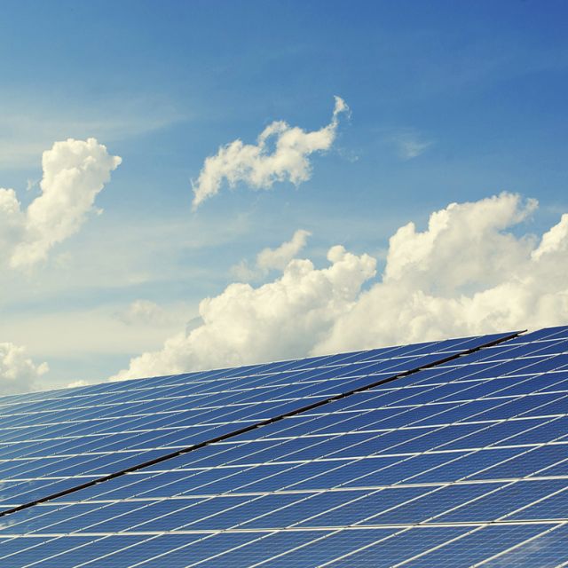 The sky and clouds reflected in solar panels