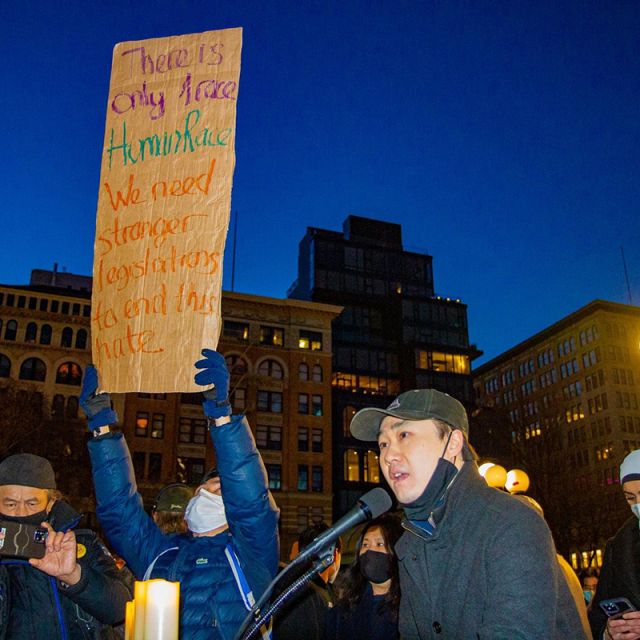 Protestors hold signs at a demonstration