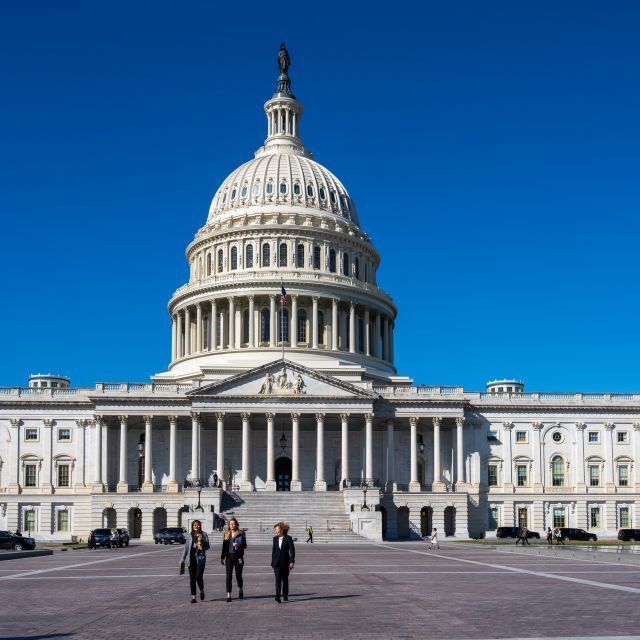 Three women walking on the East Plaza of the U.S. Capitol