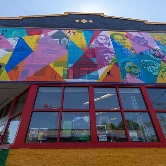 A community center in the Hilltop neighborhood with a colorful mural on the upper level of the building