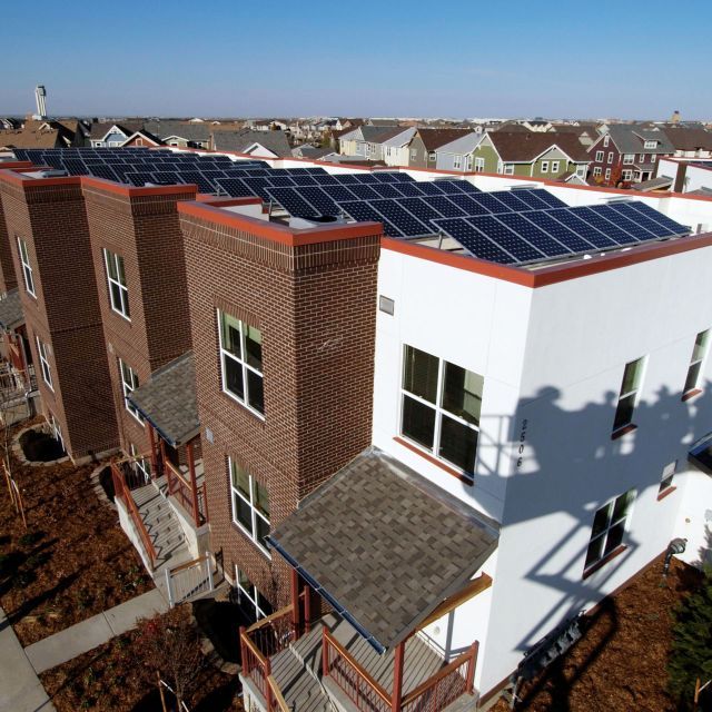 Solar panels installed on rooftops of apartment buildings in Solar Green Communities 