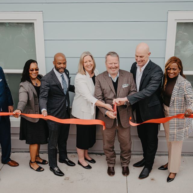 Group of People Cutting Ribbon at Bezos Academy Grand Opening