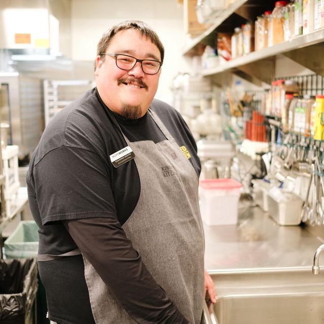 Brandon Adkins stands in front of sink