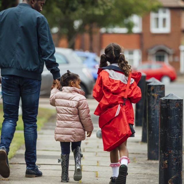 Father walking with two girls