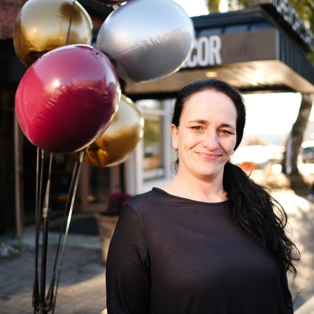 Tina Rogert in front of the HopeWorks Renew furniture store