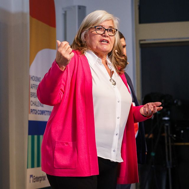 A woman speaking and talking with her hands