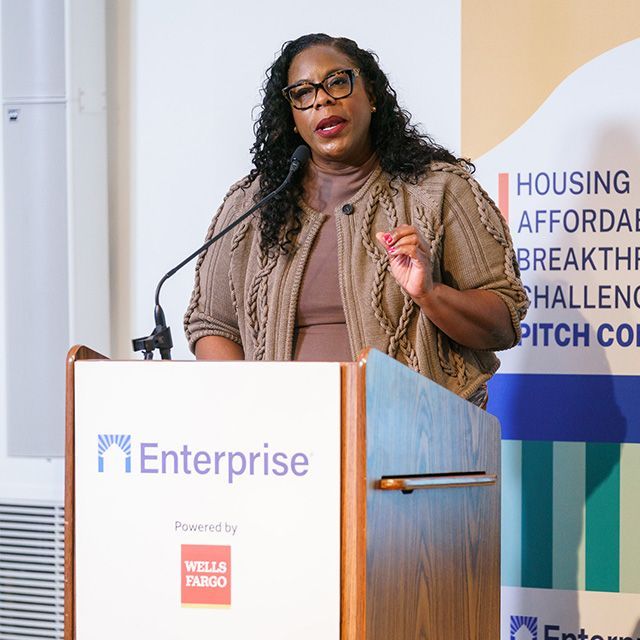 A woman standing at a podium speaking