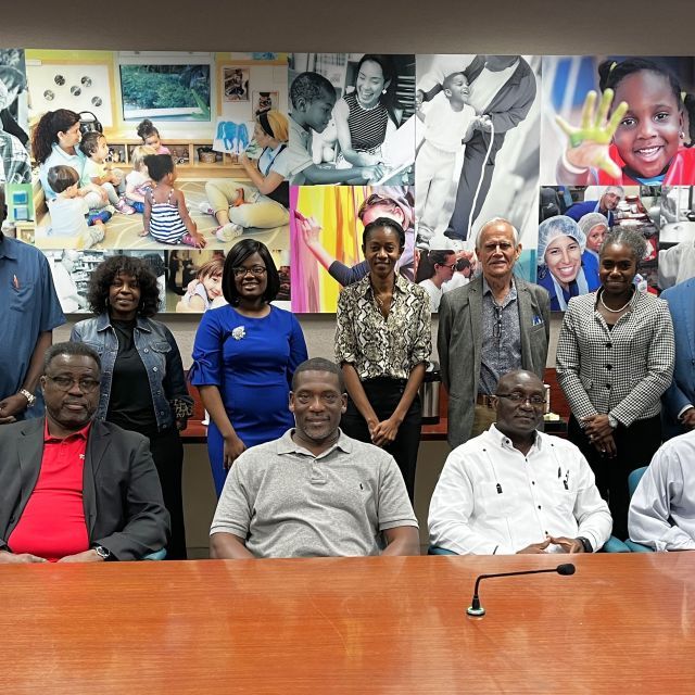 Members of the Enterprise Southeast FBDI Cohort seated at a conference table in front of a mural