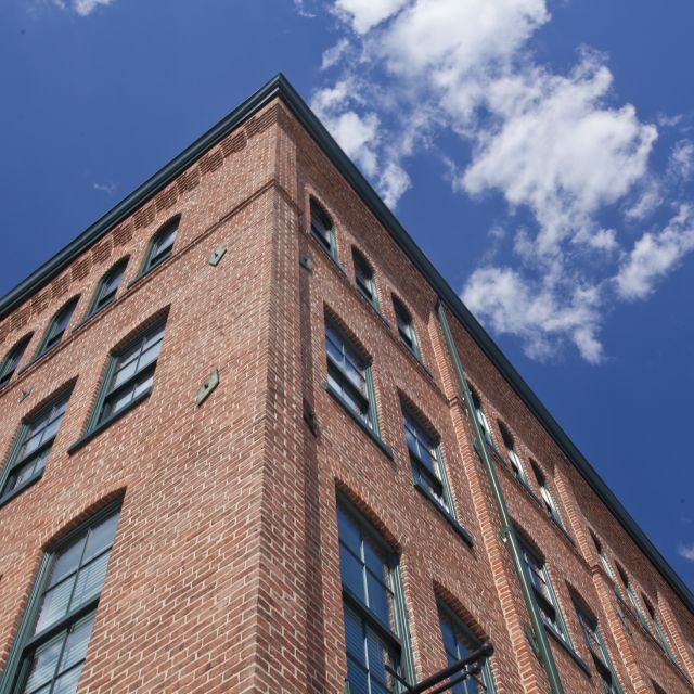 Brick building and blue sky with a few clouds