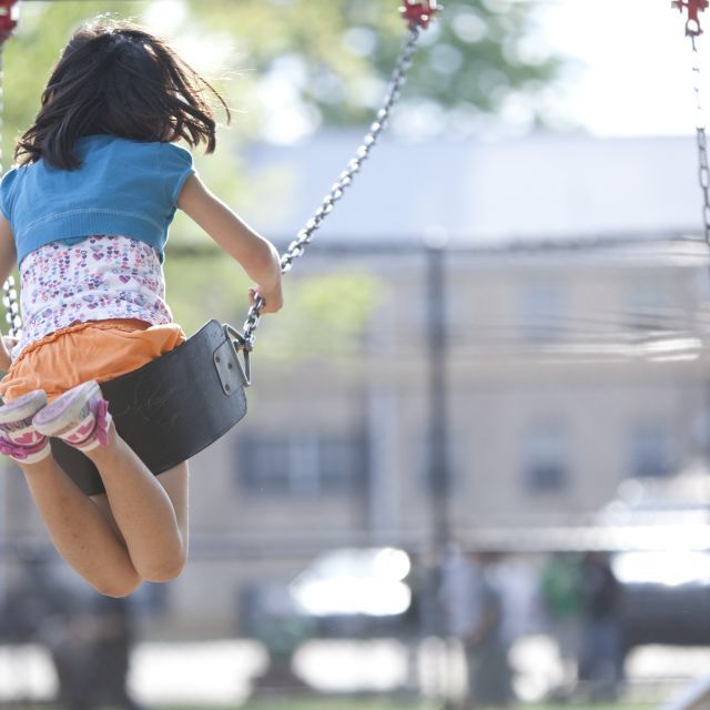 Girl in a swing at playground
