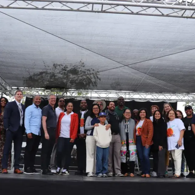 Group of smiling people standing on a stage