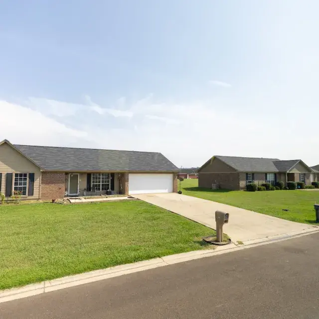 Single-family, red-brick homes surrounded by large green lawns