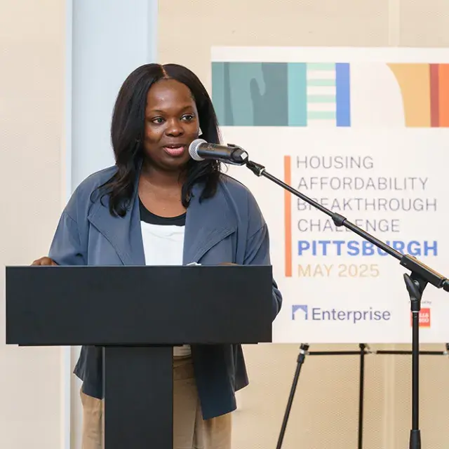 Baaba Halm standing at a podium speaking