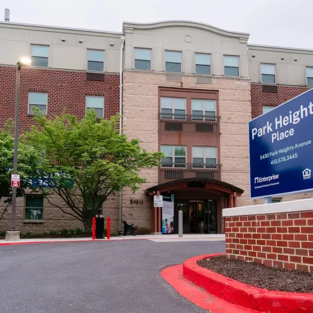 Exterior of red brick and tan building, Park Heights Place, senior housing in Baltimore