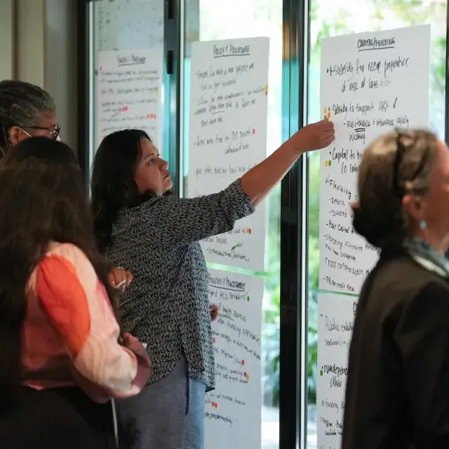 Woman placing sticker on poster paper