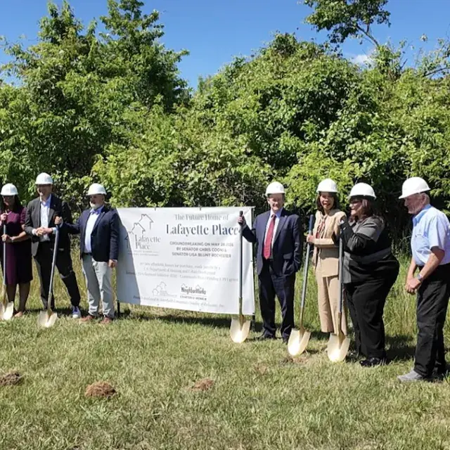Picture with shovels standing around a Lafayette Project sign
