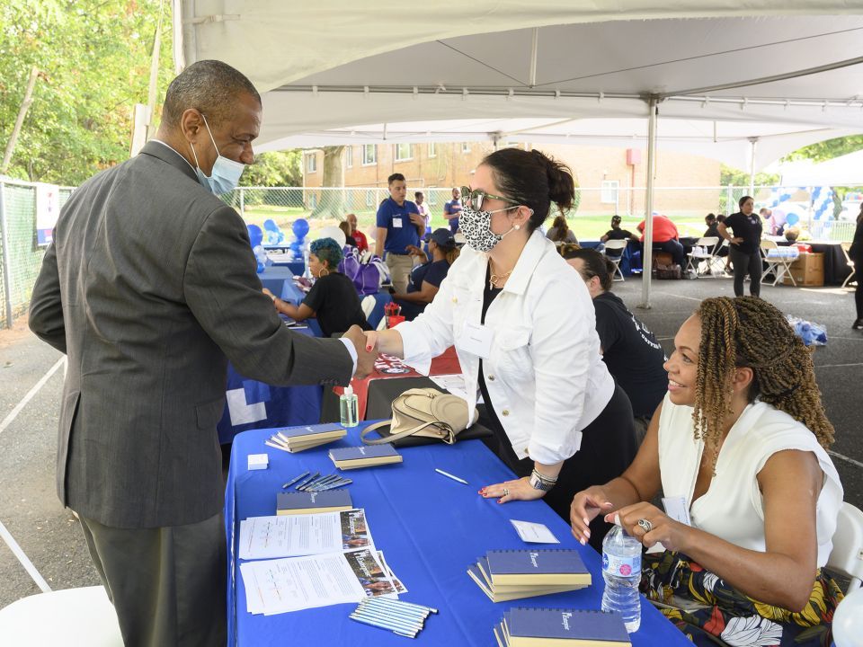 Cherry Hill Career Fair, people at booth greeting a man