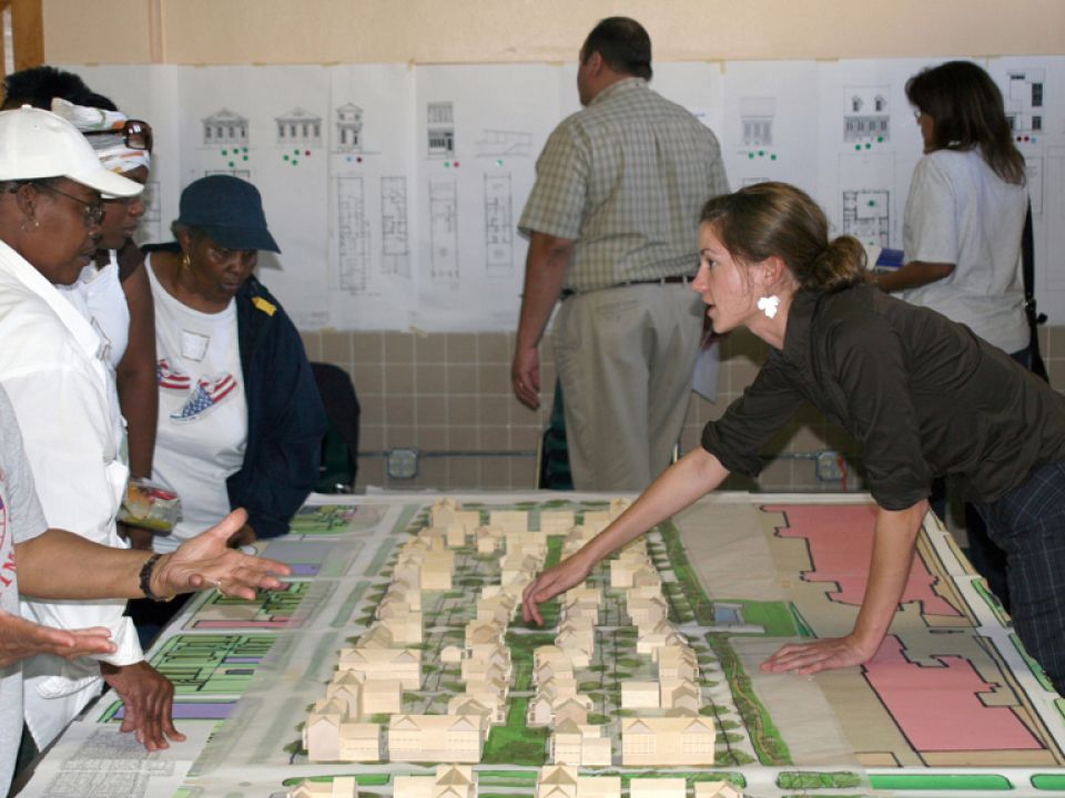Woman presenting a building diagram to a group of seniors