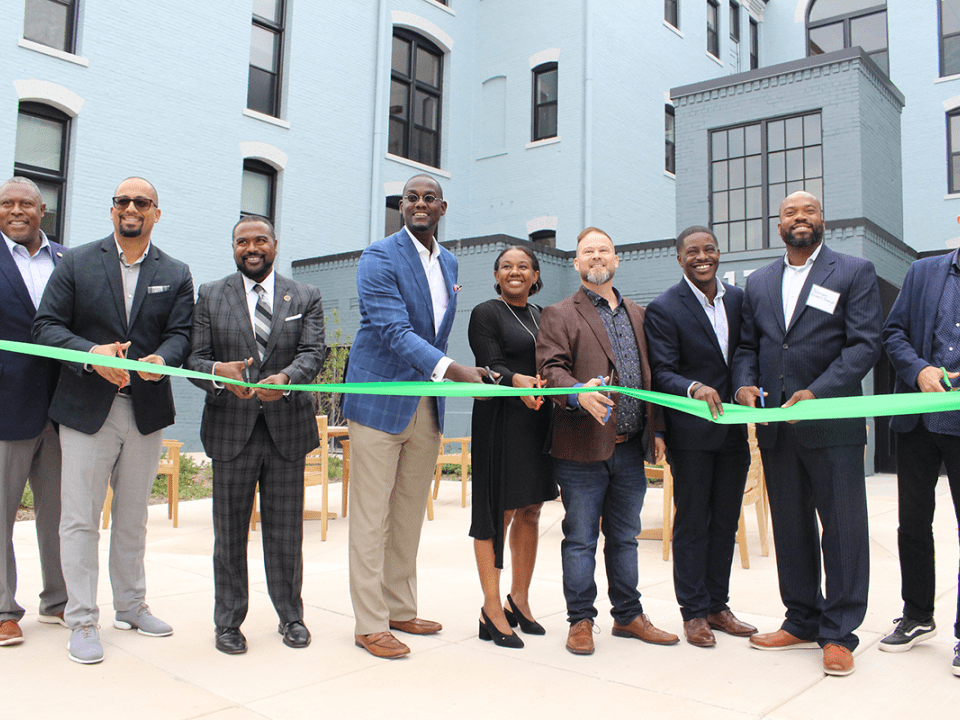 A group of people during a ribbon cutting ceremony
