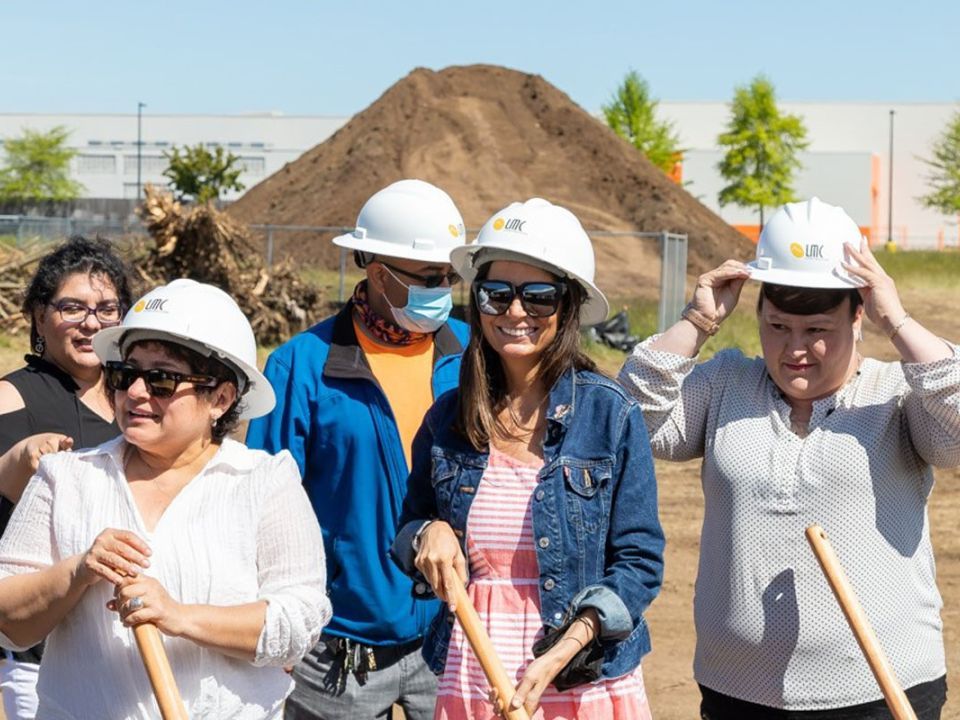 A group of 5 people wearing hard hats