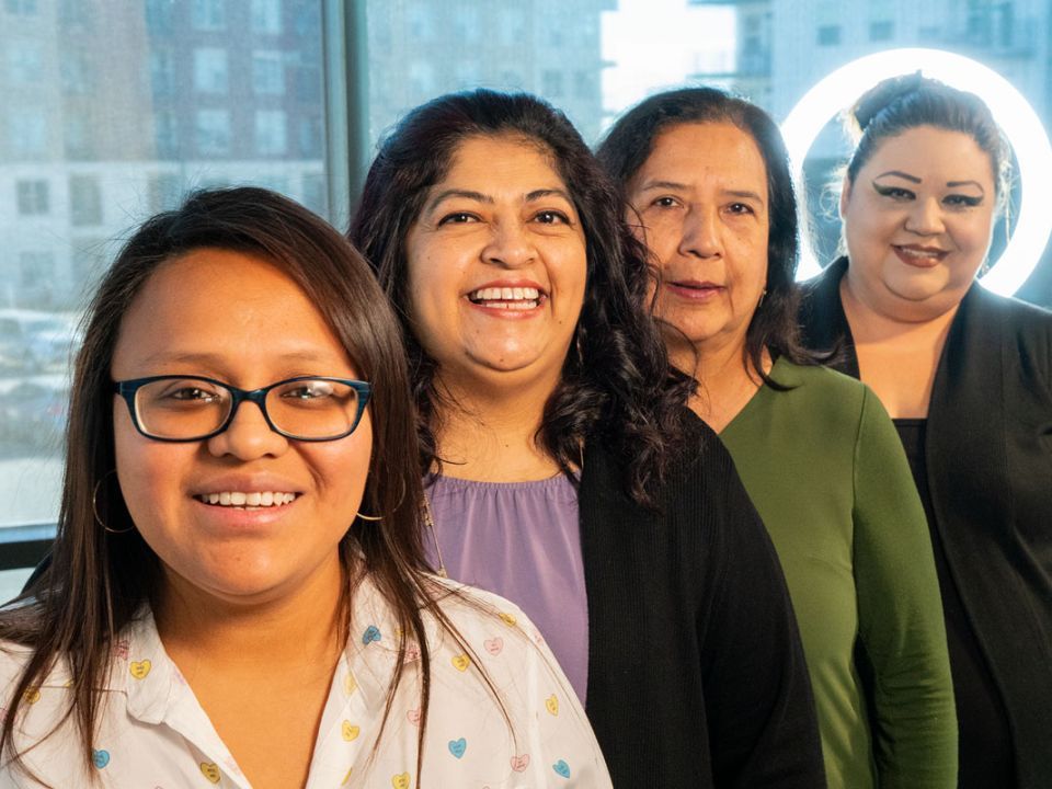 Four women stand by the window