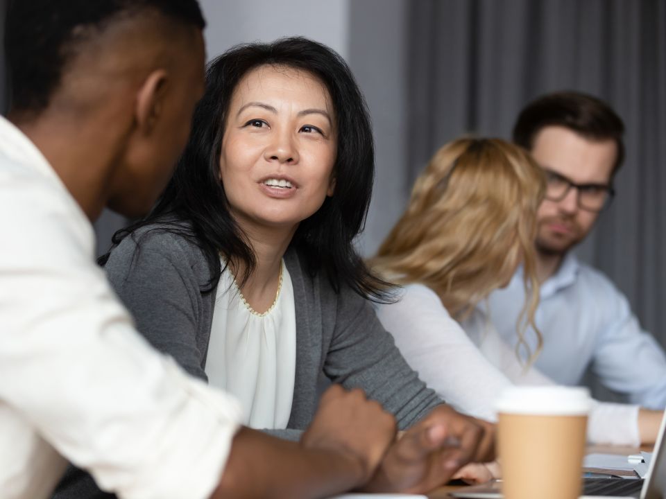 Business people at a table engaged in discussion