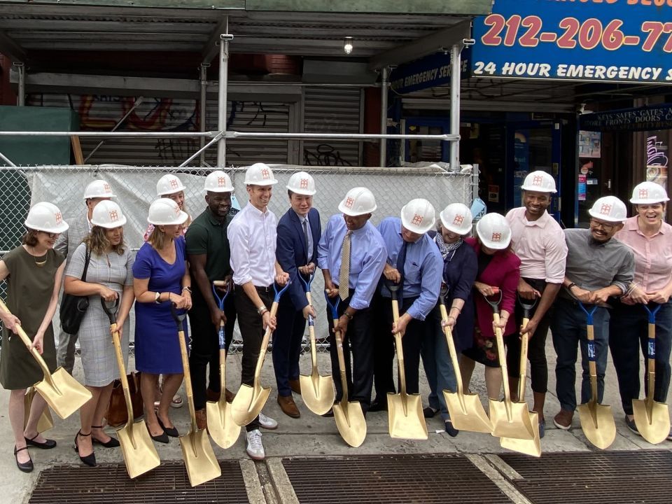 A group of people with hard hats and shovels.