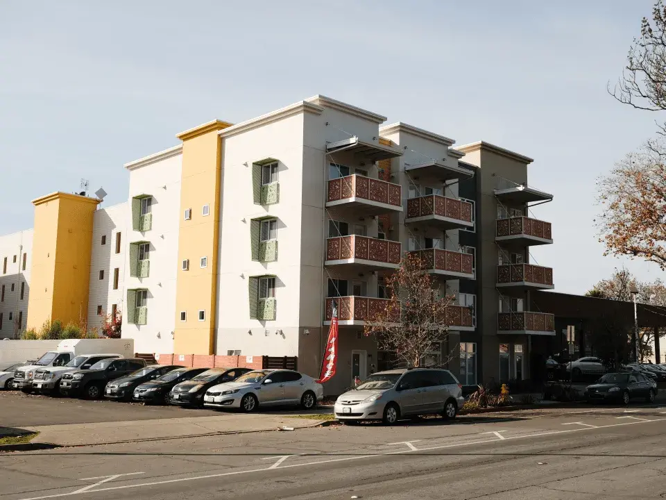 Streetview of the City Center Apartments with cars parked in the parking lots 