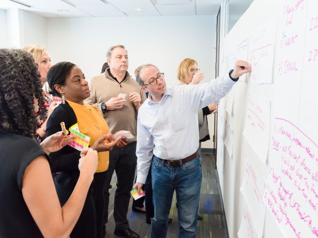 workshop attendees looking at a chart