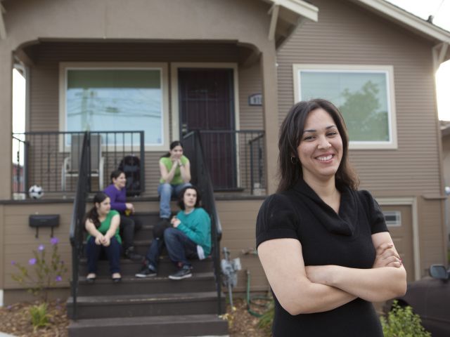 family in front of a bay area california house, kids sitting on porch steps