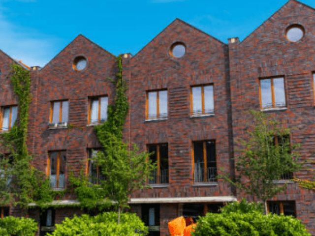 Front view of apartment buildings with landscaping