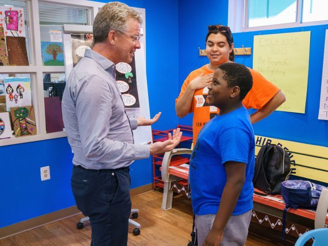 Enterprise CEO Shaun Donovan speaking with boy