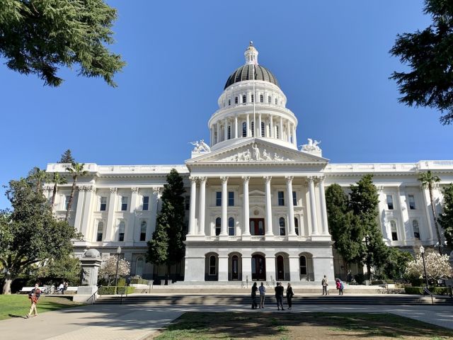 Photo of the California Capitol -- a white building with columns and dome