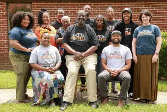 A group of individuals sitting and posing for a photo
